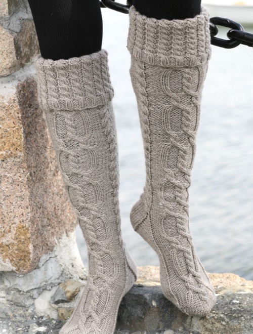 Knitted long socks with cables and folded edge